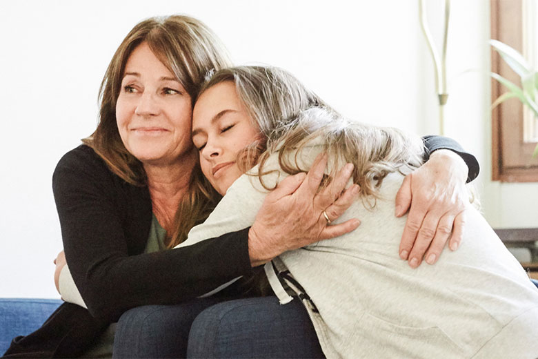 Mother and daughter hugging